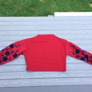 Long sleeved red shirt with embroidered roses.